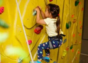 little girl rock climbing