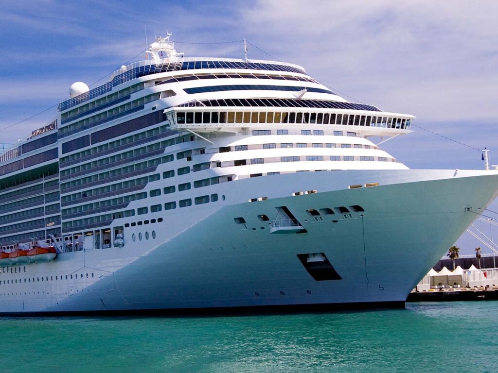 A large cruise ship docked in the ocean.