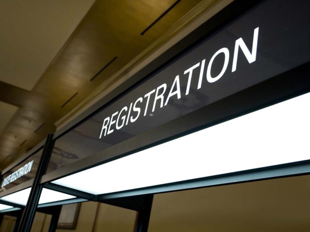 A sign that says registration in front of a building.