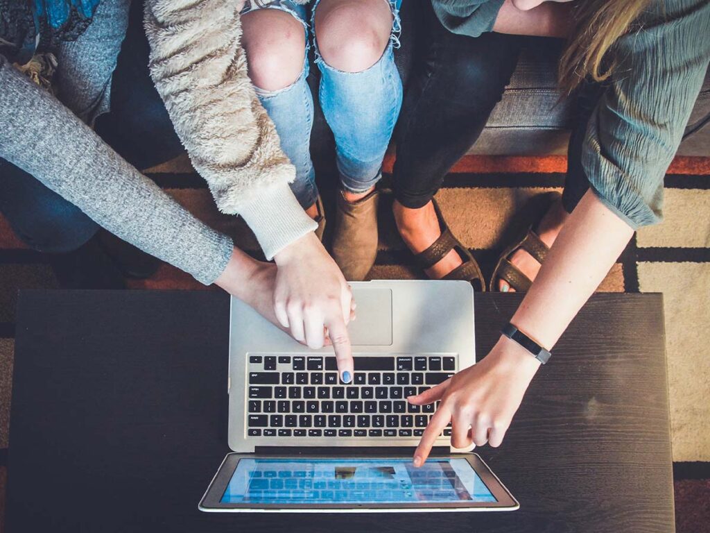 people booking a trip on a laptop