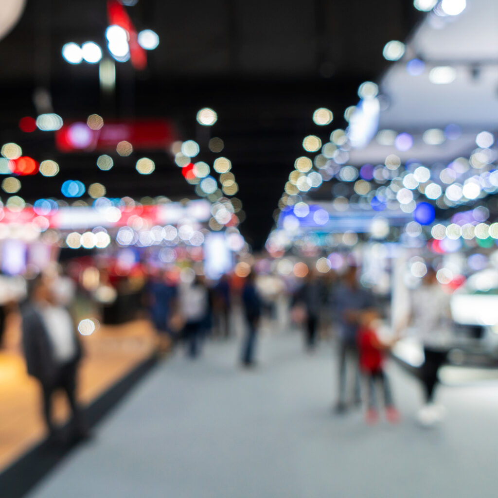 A blurry picture of people walking in an indoor area.