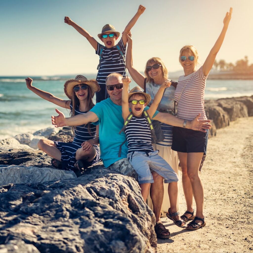 A group of people posing for the camera on the beach.