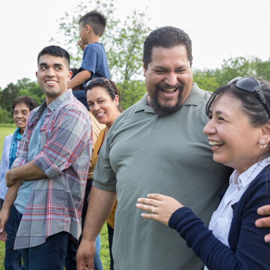 A group of people standing around each other.